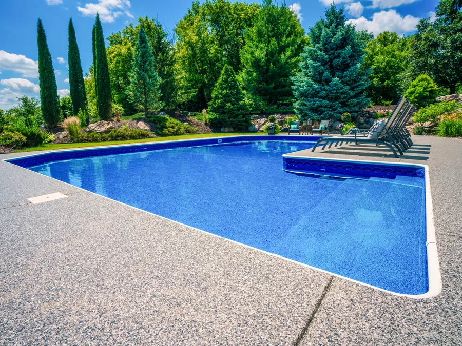 Flake pool deck coating around an in-ground pool