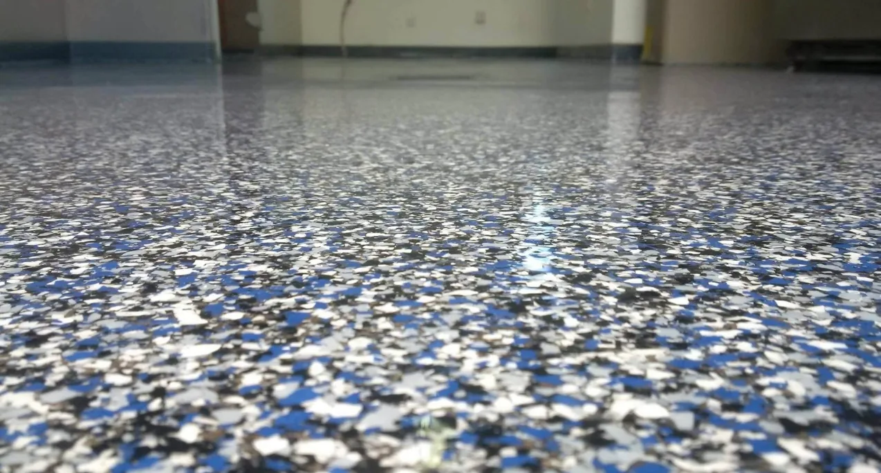 Close-up of a glossy blue, white and black full-broadcast flake floor