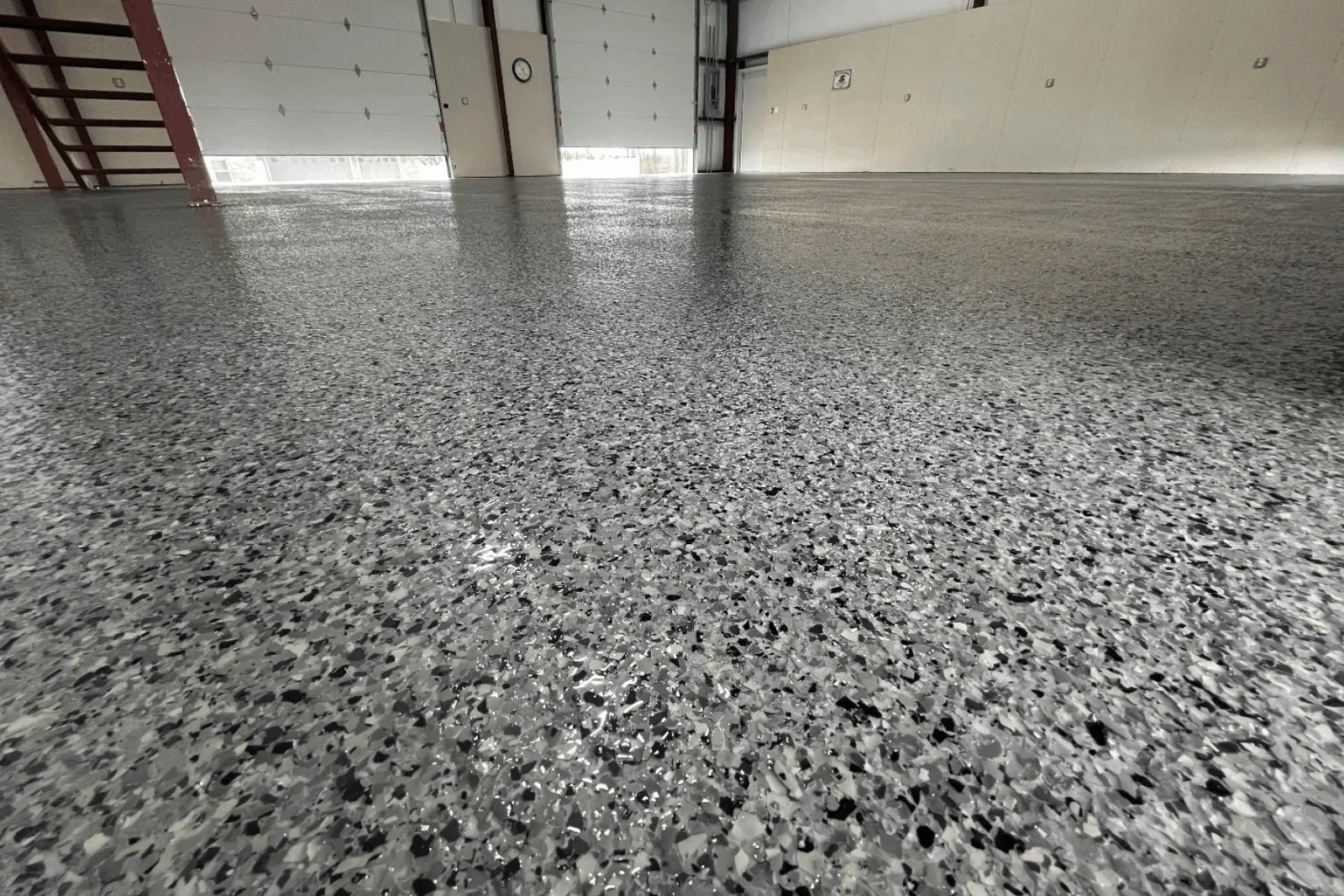 Gray flake epoxy floor across a large commercial bay