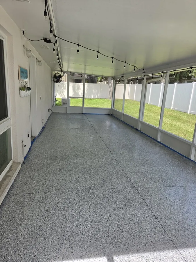 Finished gray epoxy flake floor on a screened lanai installed by Apex Epoxy Coatings
