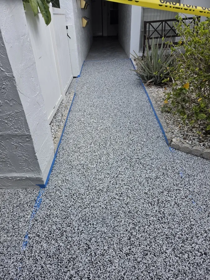 Fresh gray flake epoxy walkway coating at a Pinellas County condo community